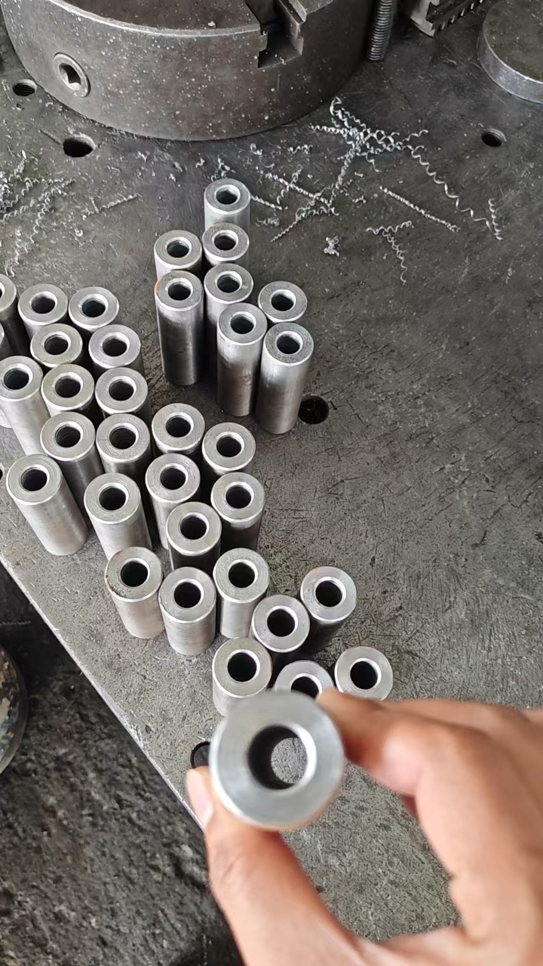 Product detail — forged component held at workshop — field photo (2026-08)